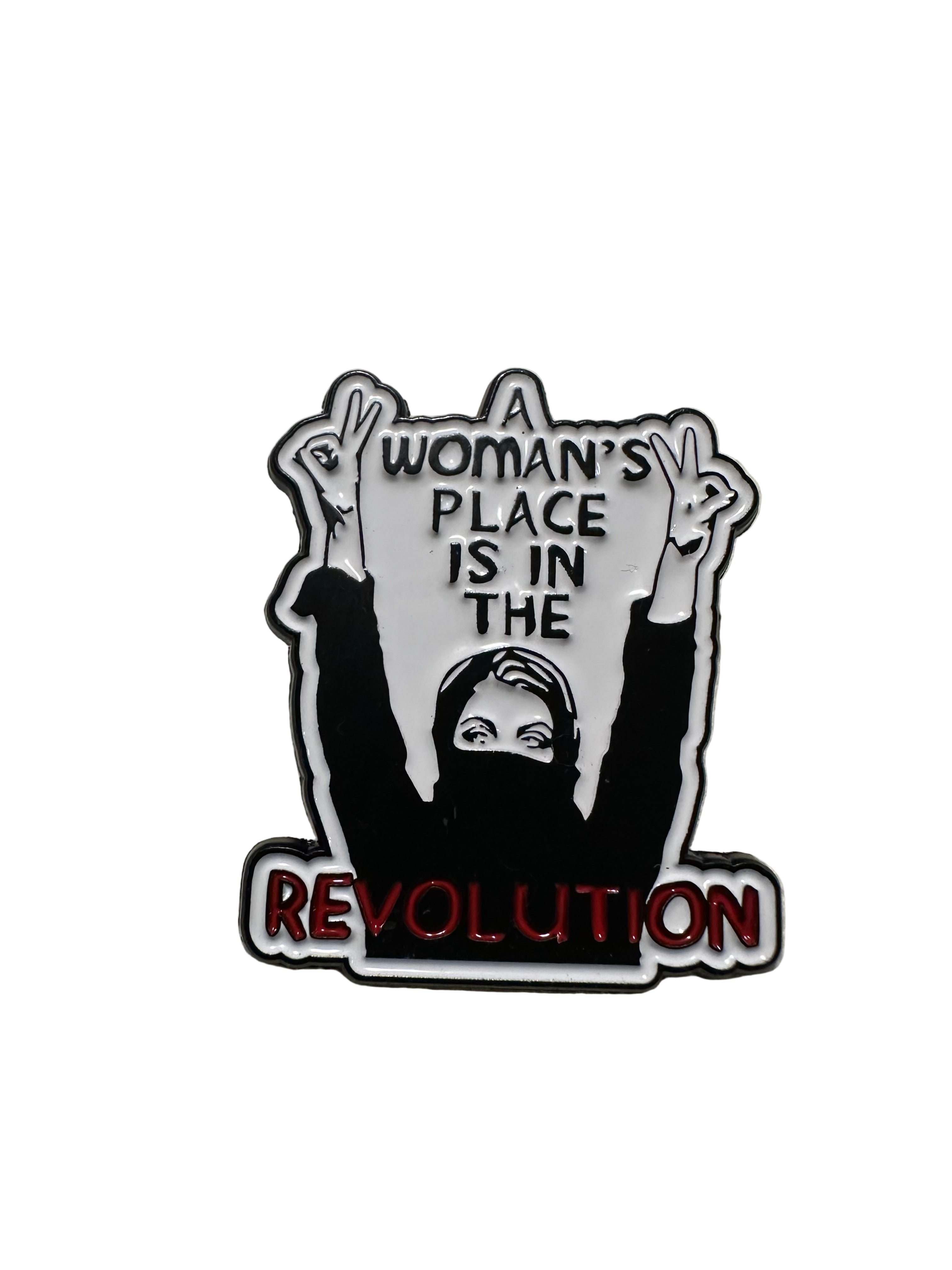 Pin with 'A woman's place is in the revolution' text on a beige background