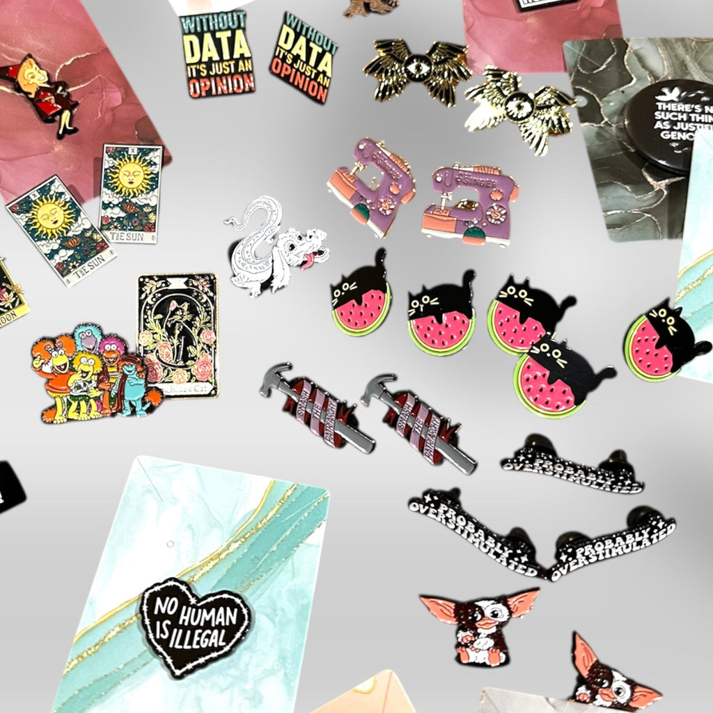 Collection of various pins and stickers on a white background